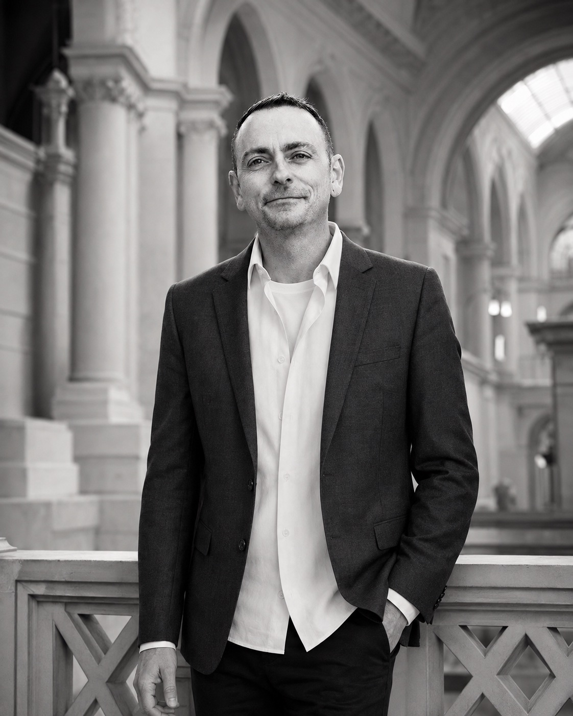 Patrik Strate standing in a grand columned interior
